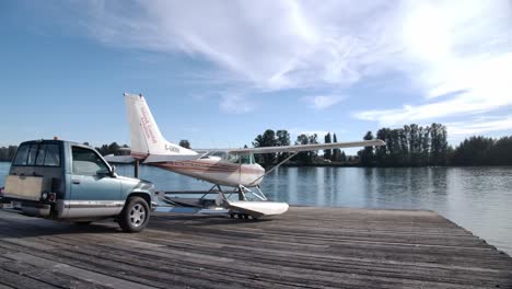 Half-Truck-Tug-Launching-Seaplane-On-Wooden-Ramp-In-Vancouver,-Canada