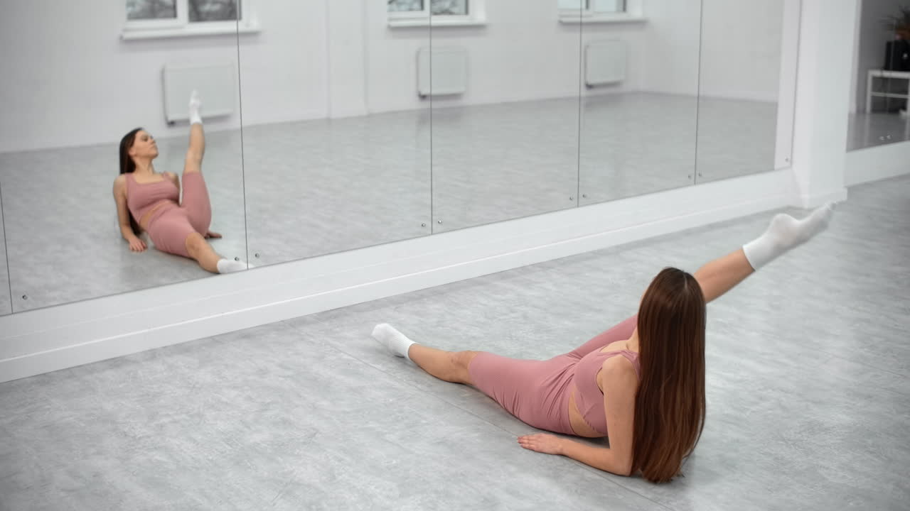 Woman Stretching in a Dance Studio