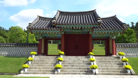 scenic gate through the peaceful garden of iconic tomb of seven hundred patriots in geumsan, chungcheongnam-do, south korea - medium shot