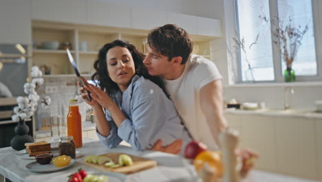 una pareja feliz hablando en la cocina cocinando el desayuno familiar de cerca. mañana romántica.