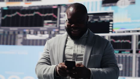 young business leader checking online fintech reports on mobile phone
