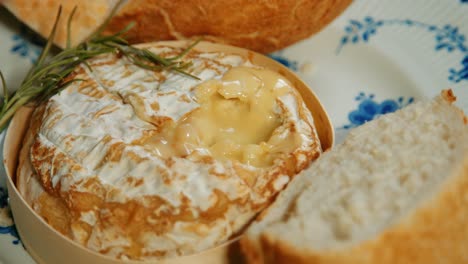 Baked-French-Camembert-Appetizer-with-Hand-Dipping-Pieces-of-Baguette-Bread