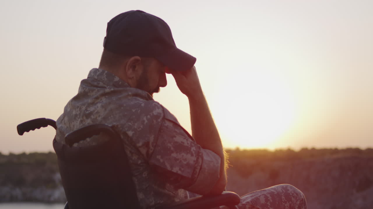 Military Veteran in Wheelchair Contemplating Sunset