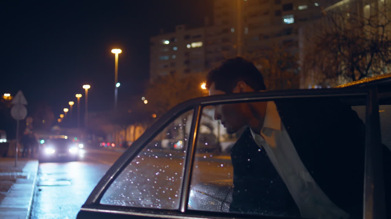 Car driver uncover door going into night street. Businessman exit black auto