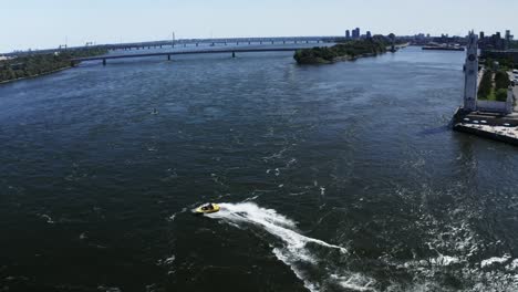 a jet boat racing across the st. lawrence river in montreal, offering tourists an adrenaline-fueled ride. the river's waves and the city skyline create an exhilarating scene. tourist destination.