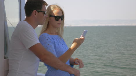 young man and woman traveling by sea