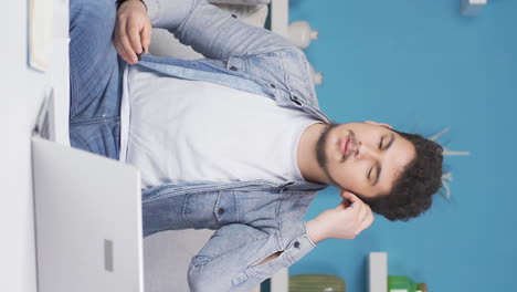 Vertical-video-of-Happy-man-listening-to-music-with-headphones.