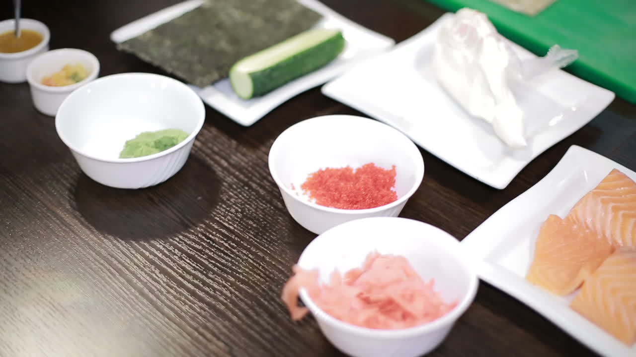 Prepare Japanese Sushi Rolls. Woman chef ready to prepare japanese sushi rolls, with principal ingredients