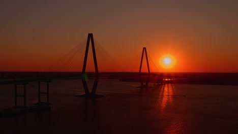 aerial drone shot of ravenel bridge at sunset, boom down, charleston, sc