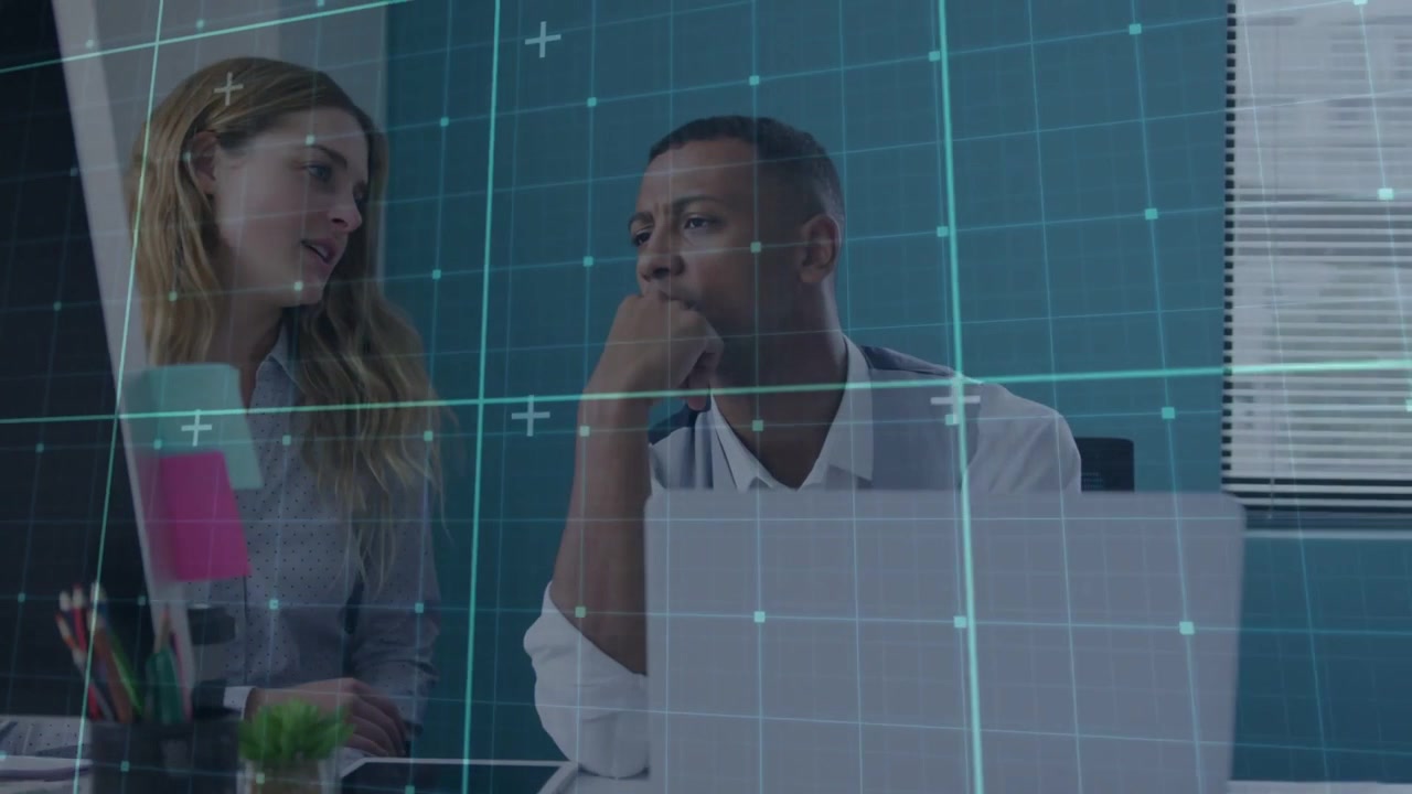 Woman leaning toward monitor and pointing, initiating grid overlay while explaining business plan