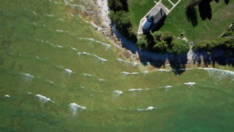 Birdseye-view-looking-straight-down-at-a-light-house-in-door-county,-Wisconsin