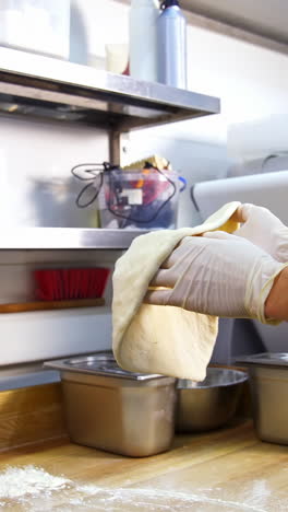 pizza dough preparation in a restaurant kitchen