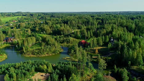 a smooth high angle shot of a village landscape with a forest and a lake