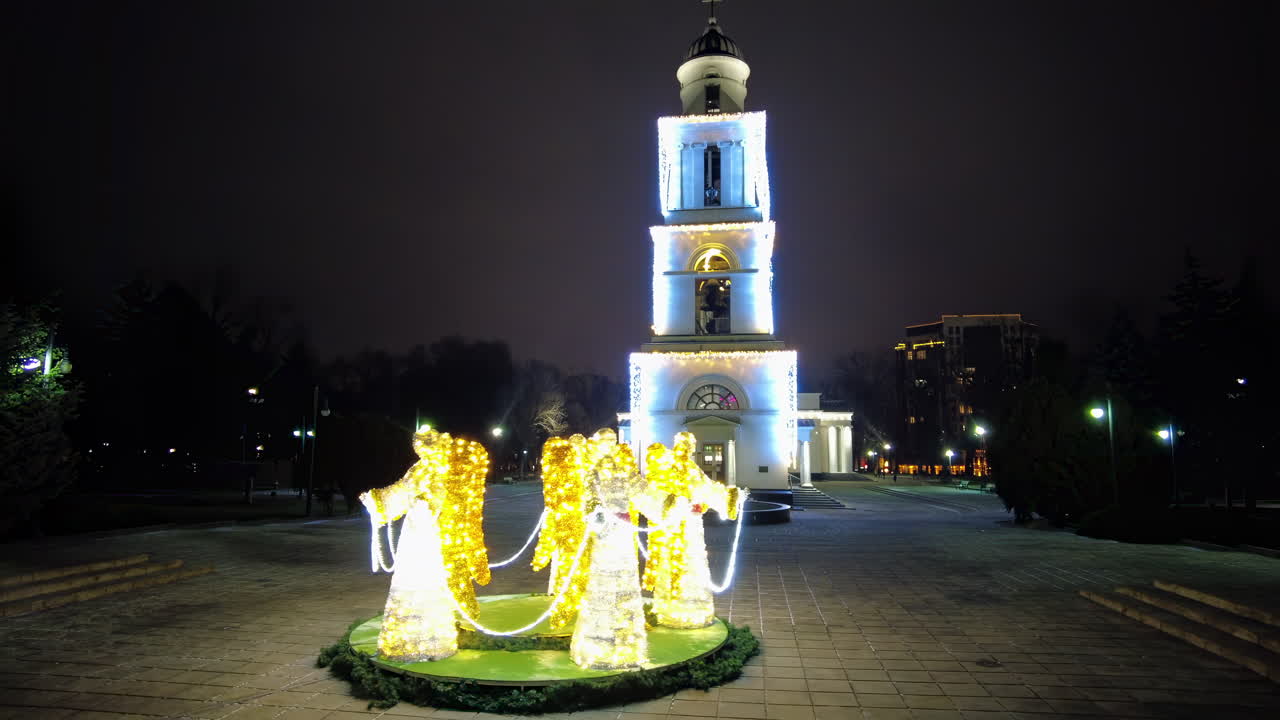 Colorful lights illuminate the city square, showcasing stunning winter decorations. The charming atmosphere invites visitors to enjoy the holiday spirit and celebrate together