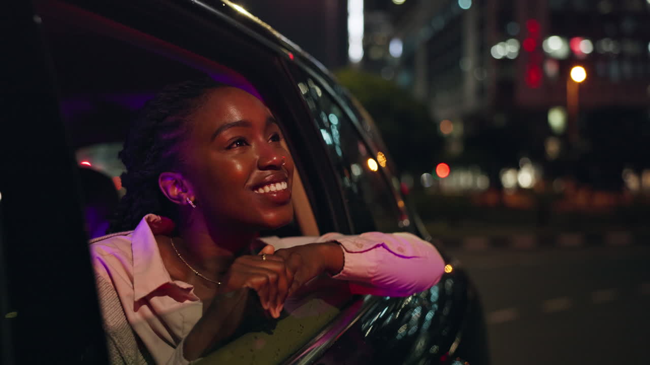 Woman enjoying a car ride at night