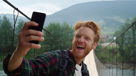 smiling tourist take selfie hold smartphone closeup. hiker posing on nature.