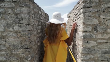 beautiful girl model in yellow dress walking on top of mayan ruin temple belize