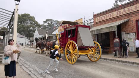 tourists observe horse-drawn carriage in historic setting