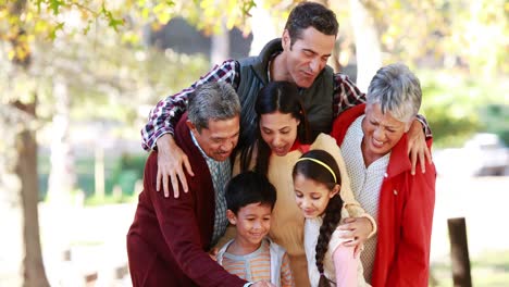 multi-generation family taking a selfie in the park