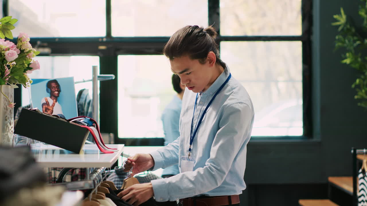 Worker arranging new fashion collection,