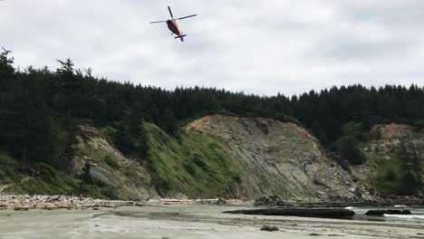 A-coast-guard-helicopter-lifting-off-above-the-beach-on-the-Oregon-Coast