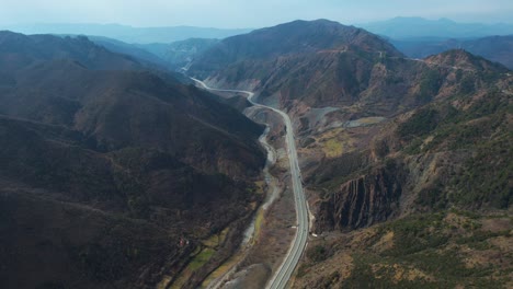 highway of kukes in albania passing through panoramic landscape on valley surrounded by mountains