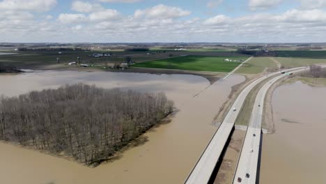 flooded road next to freeway in southern indiana with drone video circling