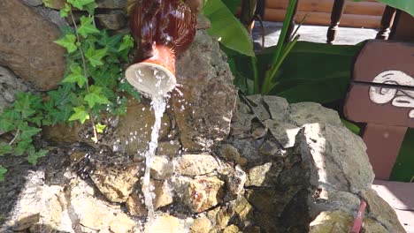 water feature with brown pottery