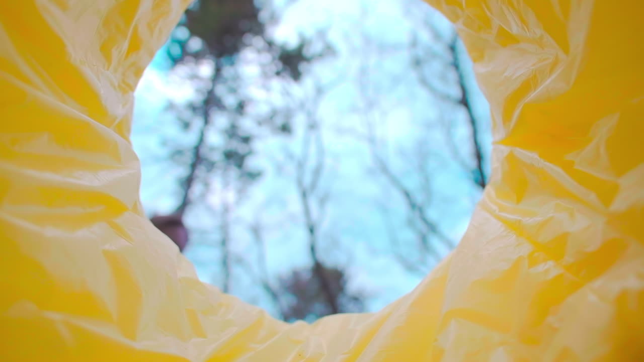 Man throwing a medical mask into a trash can. View from inside the can. Slow motion