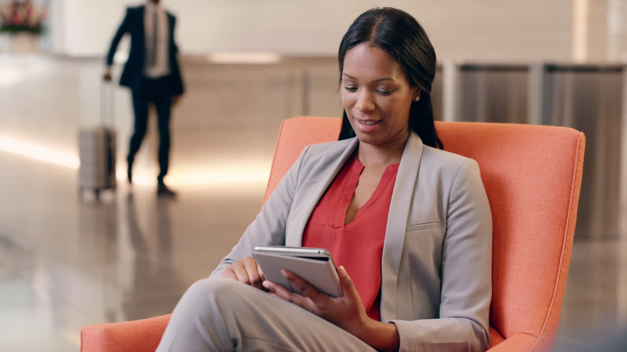 African American Businesswoman working on digital tablet in hotel lobby
