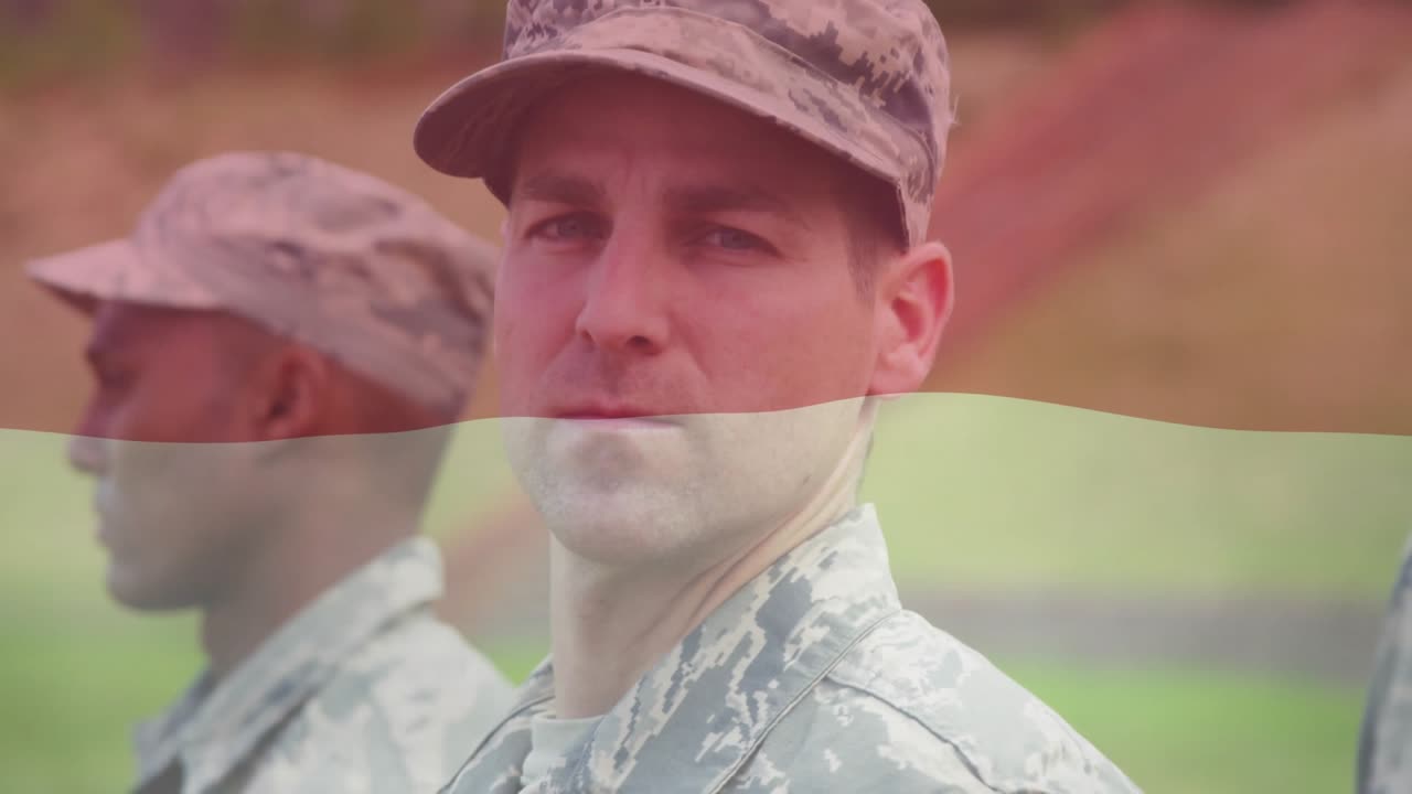 Camera zooming toward central soldier holding rigid posture and turning head for military drill
