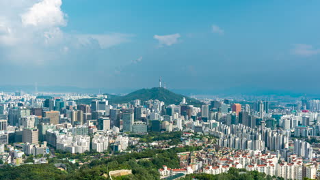 seoul summer cityscape time lapse of clouds movement above megacity, view on namsan tower, city wall from inwangsan mountain - zoom in tilt up towards sky