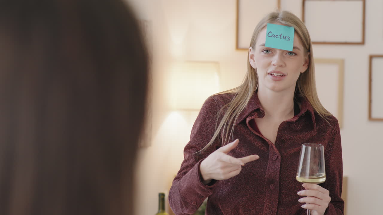 Cheerful Woman Playing Guessing Game at House Party