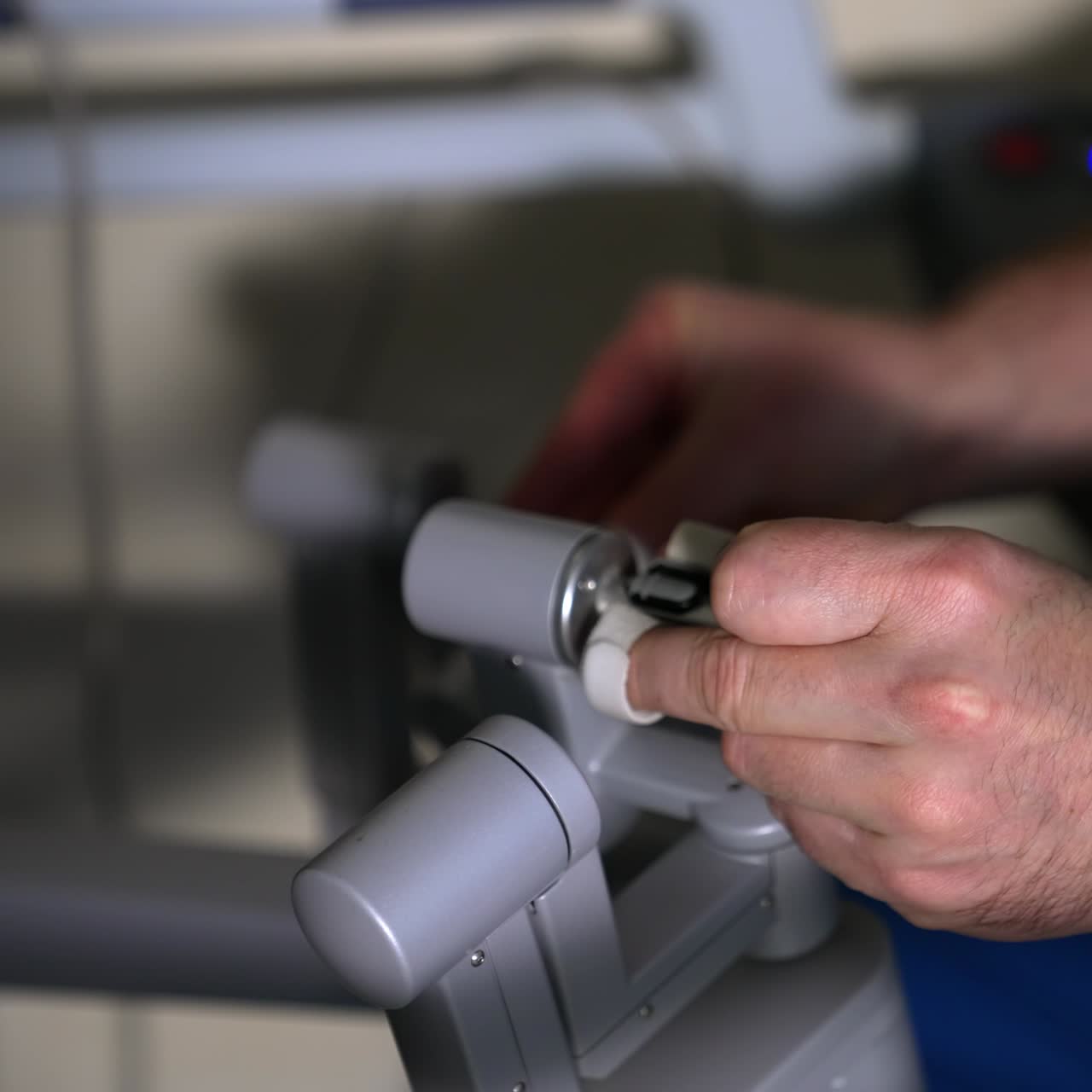 Experienced doctor working on the operating module of robotic equipment. Professional rules the arms of Da Vinci surgery system