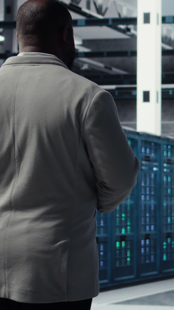 Vertical video Admin walking in data center, doing inspection on infrastructure tech