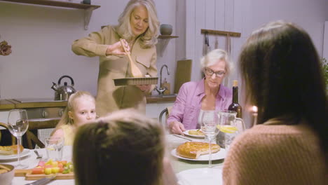 family sitting at the table during dinner at home 1