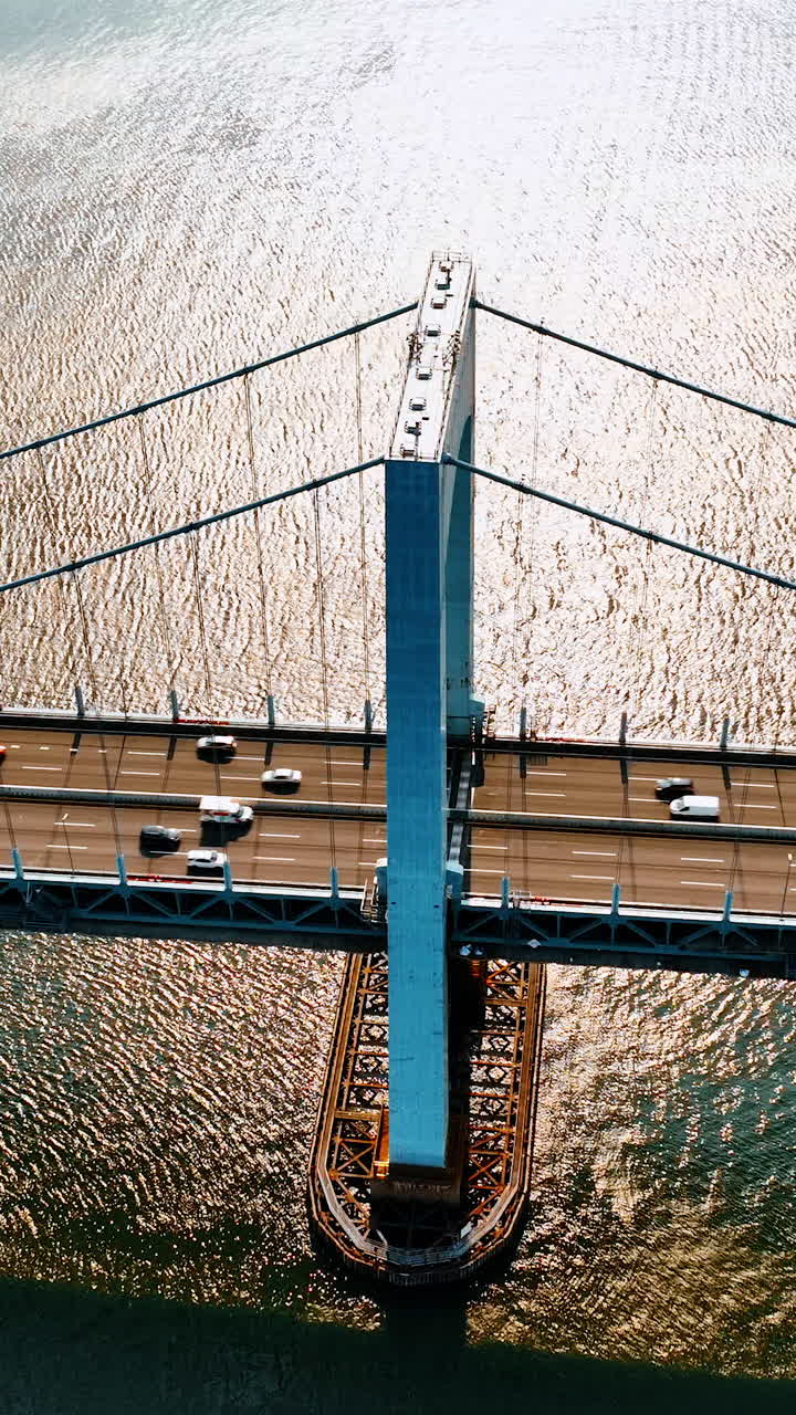Transport moving quickly by the Throgs Neck Bridge. Aerial view on the East River and suspension bridge on sunny day.