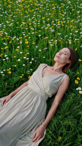 woman relaxing in a field of flowers