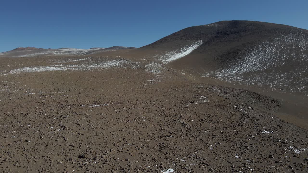 Close-up drone shot of rocky terrain beside Kollpa Lagoon in Bolivia's Sud Lipez region
