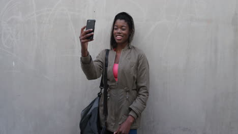 portrait-sporty-young-african-american-woman-using-smartphone-taking-selfie-photo-smiling-enjoying-mobile-connectedness-sharing-online