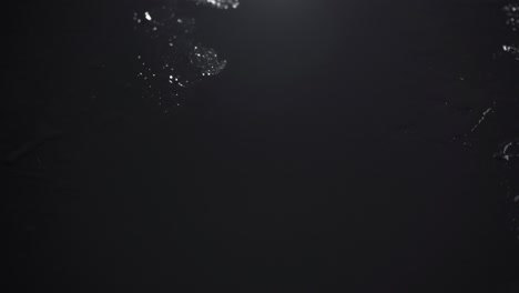 video of wet drops spray on black background