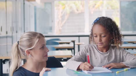 friendly female school teacher and black schoolgirl