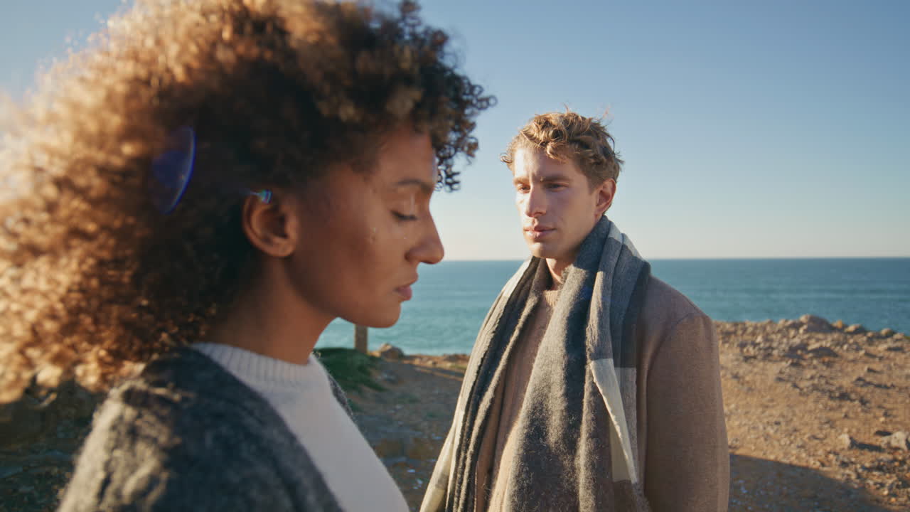 Man woman reflecting contemplation at beachside dialogue closeup. Sad people