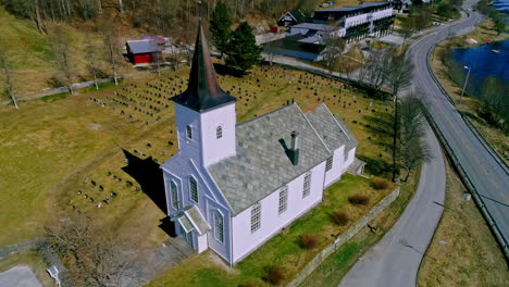 Picturesque-white-church-with-a-cemetery-in-Norway