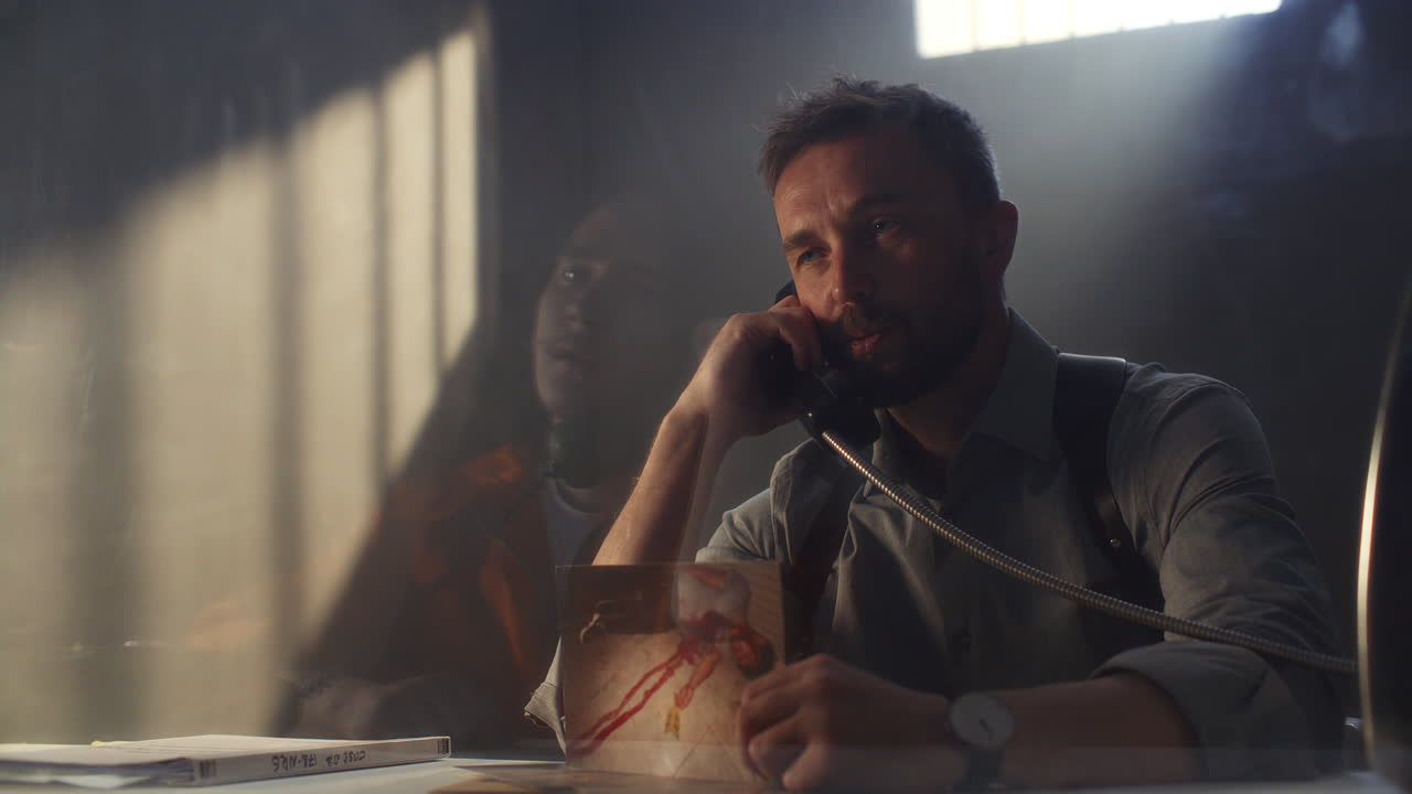 Detective Presenting Photo of Victim during Interrogation in Prison