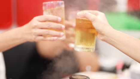 friends toasting with drinks in a lively setting