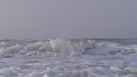 waves of the caribbean sea breaking on the sandy shore