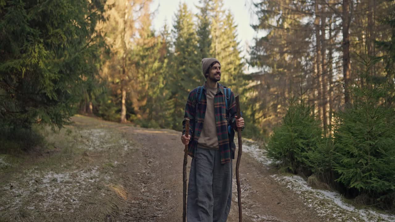 A man hiking on a forest trail