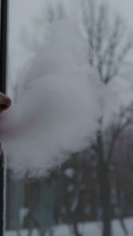 breath fogging a window on a cold winter day