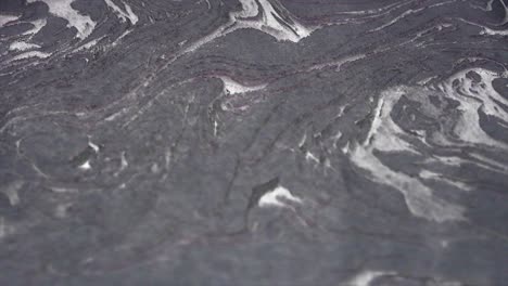 반이는 색 물질 배경 - 비스코스 물질을 시레이션하는 추상적인 애니메이션 배경 - 색 또는 가운 색의 물질이 약간 움직이고 빛은 반이는 입자에서 반사됩니다.